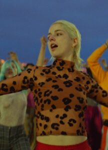 A blonde woman wears a print top