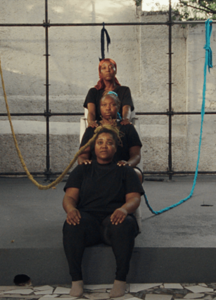 Three women are lined up in levels