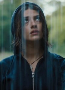 A woman wears a black hoodie