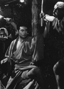 A Japanese man fights two men.