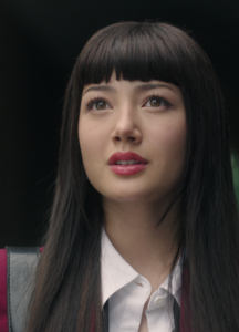 A young Janaese woman wears bangs.