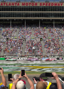 A long shot of two crowds on a track.