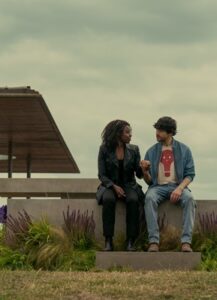 Two people sit in a public area.