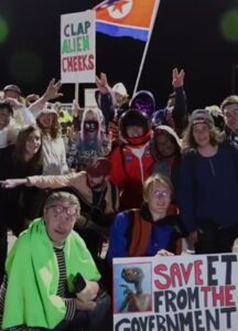 A bunch of people carry posters.