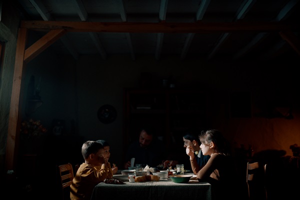 A family gathers around a table
