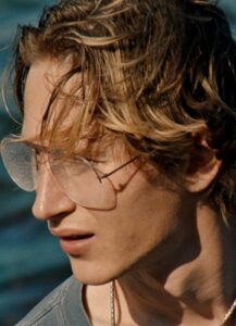 A profile picture of a man with glasses