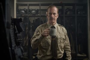 A cop has a coffee mug on his hand