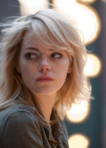 A woman looks to the camera's left