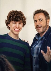 A boy and a man in front of a while background