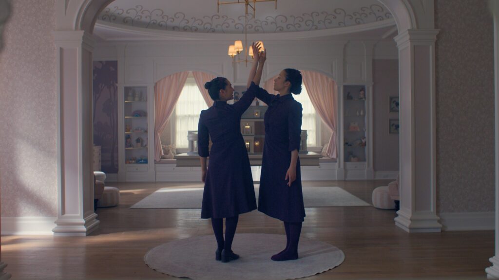 Two women are screwing in light bulbs.