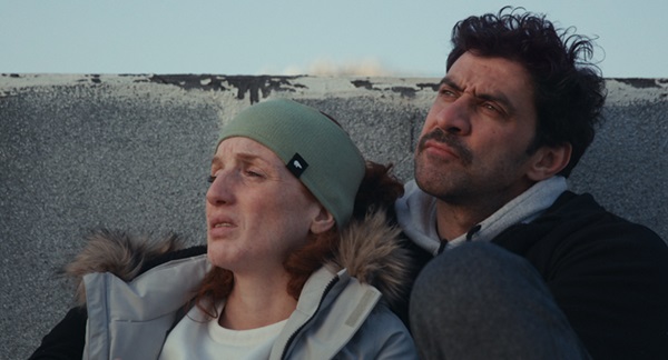 A woman and a man look up to the sky