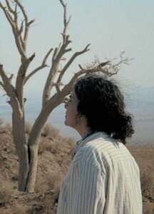 A woman looks away from the camera